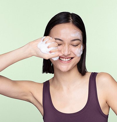 Chica sonriendo limpiandose la cara